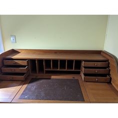 a wooden desk with drawers on top of it