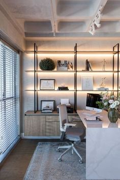 a home office with white walls and shelving