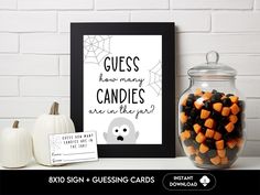 there is a glass jar with candy in it next to a sign that says guess how many candles are in the jar