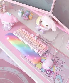 a hello kitty themed desk with keyboard, mouse and plush animal on the top shelf