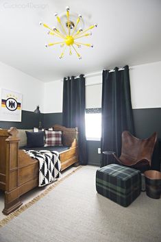 an instagram photo of a bedroom with black and white decor on the walls, green curtains, and a brown chair