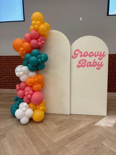 there is a balloon arch in the middle of the floor and it says groozy baby