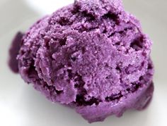 a scoop of purple ice cream on a white background