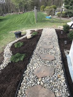 a stone path in the middle of a garden