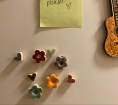 there is a guitar and some candy hearts on the table with a note attached to it