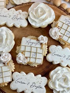 decorated cookies on a wooden platter with names and date