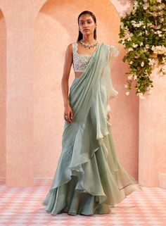 This set features an apple green embroidered raw silk blouse and printed rushed chiffon skirt with chanderi and net detailing paired with scallop embroidered organza cape. Fabric: Organza; Chiffon;... Ruffled Saree, Green Sari, Ridhi Mehra, Ruffle Saree, Saree Designs Party Wear, Drape Saree, Net Saree, Jennifer Winget, Dress Indian Style