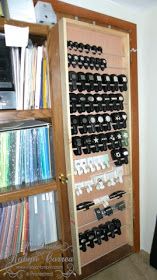 a book shelf filled with lots of books next to a wall mounted tv and dvd's