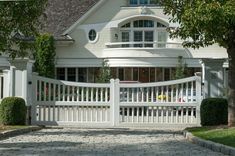 a house with a white picket fence in front of it