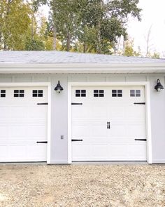 two white garages with black trim and windows