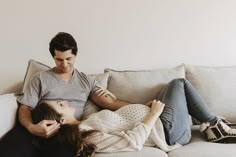 a man and woman sitting on a couch together