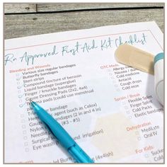 a blue pen sitting on top of a paper with an application form next to it