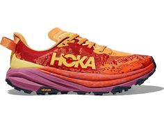 an orange and pink shoe with the word hoka in yellow on it's side