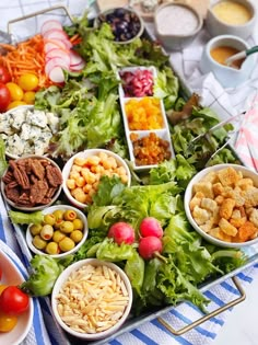 a table filled with lots of different types of salads and dips on top of it