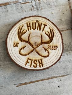 a wooden sign that says hunt eat sleep fish