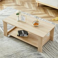 a coffee table sitting on top of a wooden floor next to a couch and rug