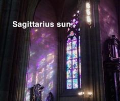 there is a stained glass window in the middle of this building that says sagittarius sun