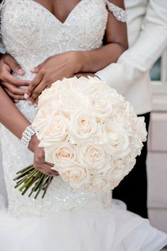 the bride and groom are holding their bouquet