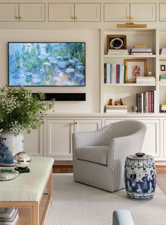 a living room filled with furniture and a painting on the wall