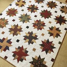 a quilted table topper with many stars on it