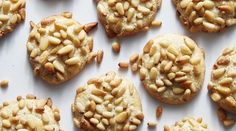 cookies with nuts are arranged on a white surface