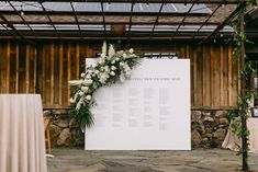 a wedding ceremony setup with flowers and greenery