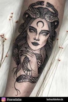 a woman's leg with an intricate tattoo design on the side of her leg