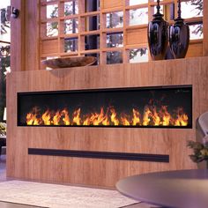 a modern fireplace in a living room with wood paneling and glass doors on the windowsill