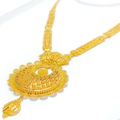 This 22k gold set, weighing a luxurious 60.7 grams, features an extravagant netted floral design that marries sophistication with intricate artistry. The yellow gold finish beautifully highlights the delicate floral motifs, giving the set a lavish and elegant allure. The set's 24-inch length is enhanced by an impressive 3.5-inch drop, and 0.6 inches of adjustable links provide a perfect, customizable fit. A reliable hook lock ensures the necklace stays secure, while the matching 1.5-inch earring Luxury 22k Gold Jewelry For Reception, Luxury 22k Gold Bollywood Necklace, Luxury 22k Gold Hand Set Necklace, Hand Set 22k Gold Luxury Necklace, Luxury 22k Gold Traditional Jewelry, Luxury Long Gold Sets, 22k Yellow Gold Temple Necklace For Wedding, Wedding 22k Yellow Gold Temple Necklace, 22k Yellow Gold Bridal Necklace For Festivals