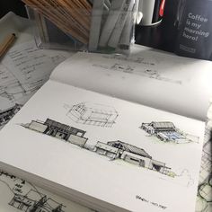 some drawings and pencils on a table