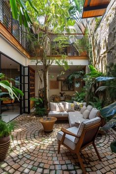 an outdoor living room with lots of plants and potted trees in the corner,