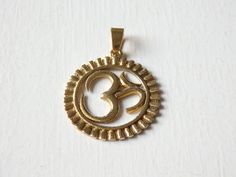 "A beautiful, brass Om pendant from Nepal. It comes with bail already attached, ready for threading on to leather, cord or chain. These lovely gold-tone Nepalese brass pendants measure 26mm (1\") in diameter. The bail has an inside diameter of approximately 4mm. The last picture shows the reverse side of the pendant. This listing is for ONE pendant. Other Nepali 'Om' pendants available in other styles! Check out the Pendants section and the 925 Sterling silver section to see all available pendan Nickel-free Gold Jewelry For Festivals, Cadmium-free Brass Pendant Necklace, Ohm Pendant, Om Pendant, Brass Pendants, The Last Picture Show, Threading, Leather Cord, Picture Show