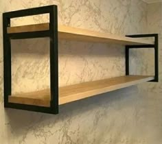 two wooden shelves on the wall with black brackets