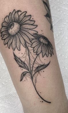 a black and white photo of a sunflower tattoo