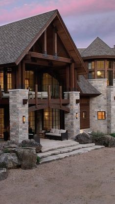 a large house with stone and wood accents