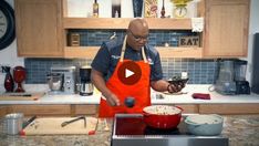 a man in an orange apron is preparing food