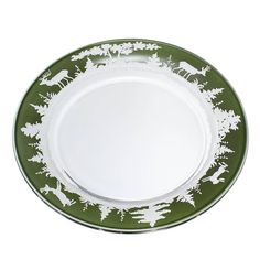 a green and white dinner plate with deer, trees, and snowflakes on it