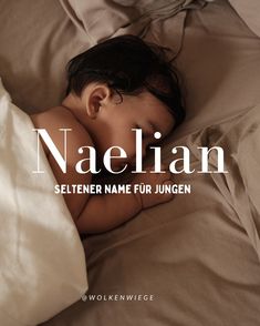 a baby is sleeping on a bed with the name naellan written in white