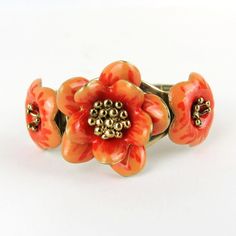 Gorgeous vintage articulated bracelet with enameled flower.       Condition:  Very good preowned condition.  Creator: -  Materials and Techniques:  metal, enamel  Marks:    Date (~):  1960s  Place of Origin:  France  Measurements: Diameter interior 5,5 cm, middle flower 3,5 cm  Weight: circa 70 gr Unique Enamel Flower Shaped Jewelry, Unique Enamel Flower Jewelry, Vintage Orange Flower Jewelry, Orange Vintage Flower Jewelry, Adjustable Vintage Enamel Bracelets, Retro Enamel Bracelet For Gift, Retro Enamel Bracelets For Gift, Retro Enamel Bracelets For Gifts, Handmade Enamel Bangle