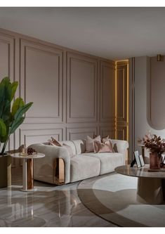 an elegant living room with white couches and gold trimmings, marble flooring