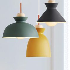 three different colored lamps hanging from the ceiling