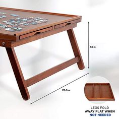 a wooden table with two drawers and one drawer on the bottom, has a puzzle design on it