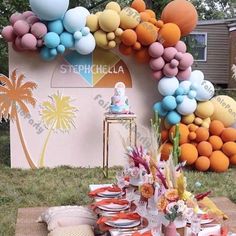 the table is set up with balloons and plates