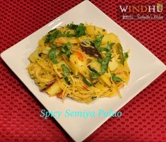 a white plate topped with pasta and vegetables