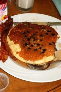 a plate with pancakes and bacon on it