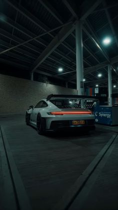 a white sports car parked in a parking garage