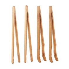 four wooden toothbrushes lined up in a row