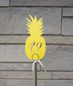 a pineapple cut out on top of a metal pole