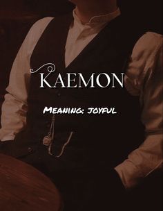 a man wearing a black vest and white shirt with the words kalemon on it