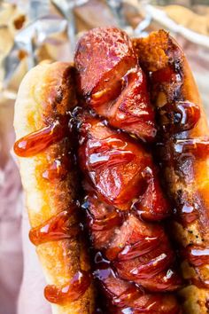 a hot dog with bacon and ketchup on it